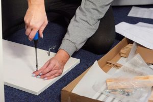 What is the gig economy? Woman working on flat pack furniture