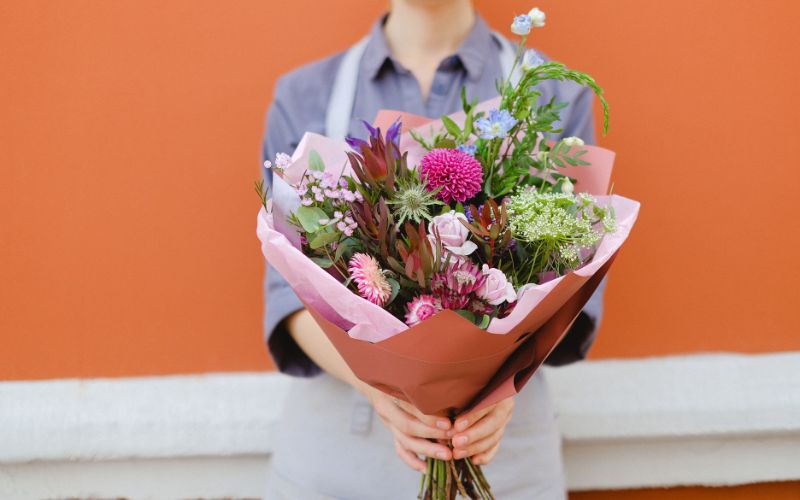 Floristry Side Hustle - Woman holding arrangement